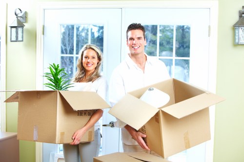 Packed boxes and furniture ready for a residential move in Acton