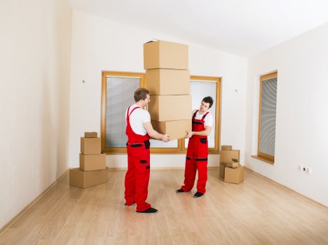 Loading furniture into a van during an Acton removal job